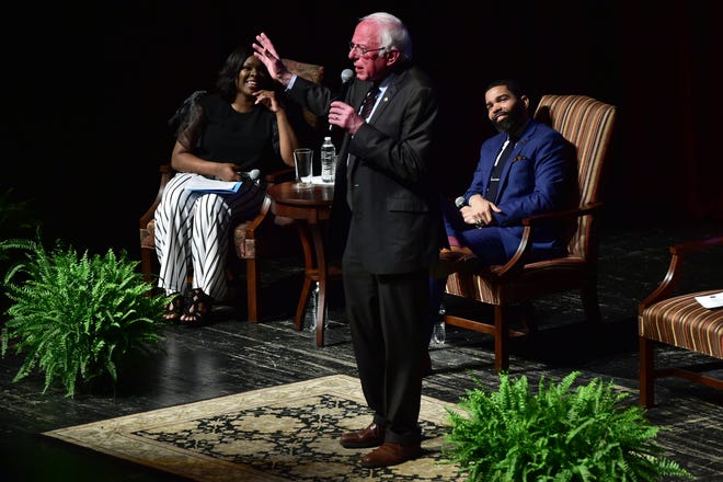 Jackson Mayor Chokwe Antar Lumumba, right, listens as U.S. Sen. Bernie Sanders, center, of Vermont answers a question during a town hall meeting Wednesday in Jackson, Miss. examining economic justice 50 years after the assassination of Dr. Martin Luther King Jr. Wednesday, April 4, 2018.