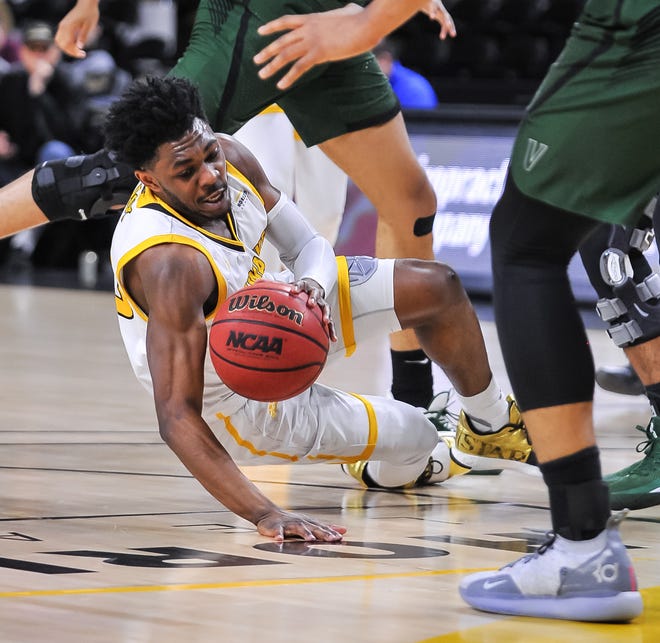 UW-Milwaukee guard Darius Roy falls after being fouled by Cleveland State forward Jaalam Hill, above, Thursday night at the UW-Milwaukee Panther Arena.