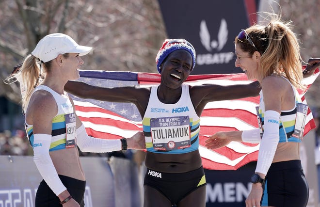 Aliphine Tuliamuk of Flagstaff won the U.S. Olympic Marathon Trials women's title Saturday. She celebrates with her Northern Arizona Elite teammates Kellyy Taylor, left, and Stephanie Bruce, who also were in the top 10.