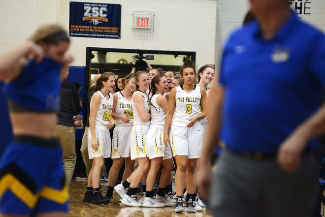 Tri-Valley's bench celebrates following a 44-41 win against Maysville in a Division II district final at West Muskingum's Gary Ankrum Gymnasium.