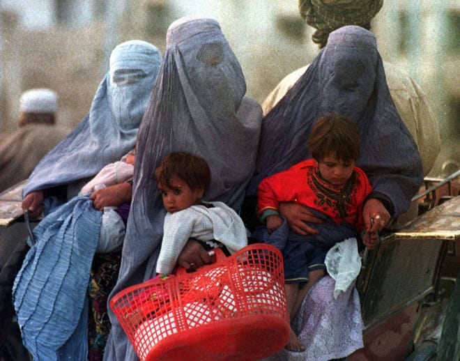 Three Afghan women in burqas in 1996 after the Taliban religious army took over Kabul.