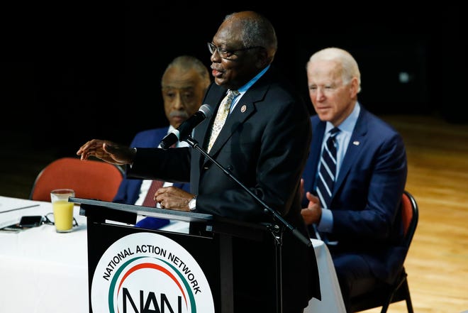 Democratic presidential candidate former vice president Joe Biden, right, and Reverend Al Sharpton, left, listen to representative James Clyburn, DS.C., speak on February 26 at the National Action Network South Carolina Minister's Breakfast.
