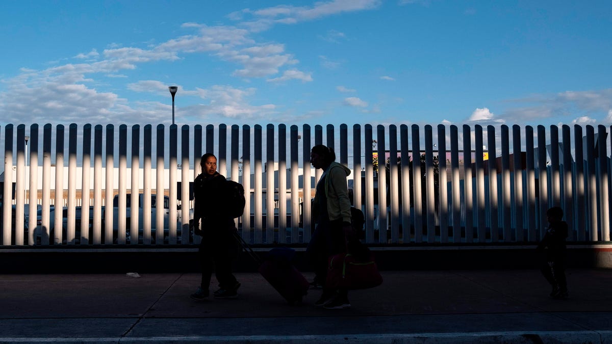 Asylum seekers wait for their turn to cross  to the United States at El Chaparral crossing port on the US/Mexico Border in Tijuana, Baja California state, Mexico, on February 29, 2020. 