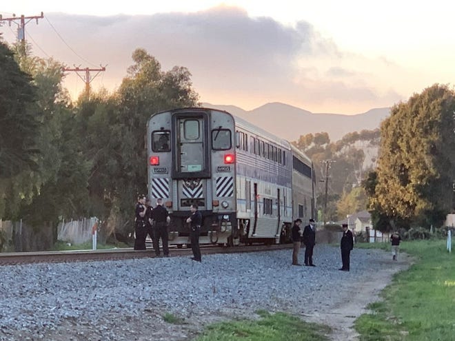 Authorities search the scene after a woman was killed by an Amtrak train in Ventura late Saturday afternoon.