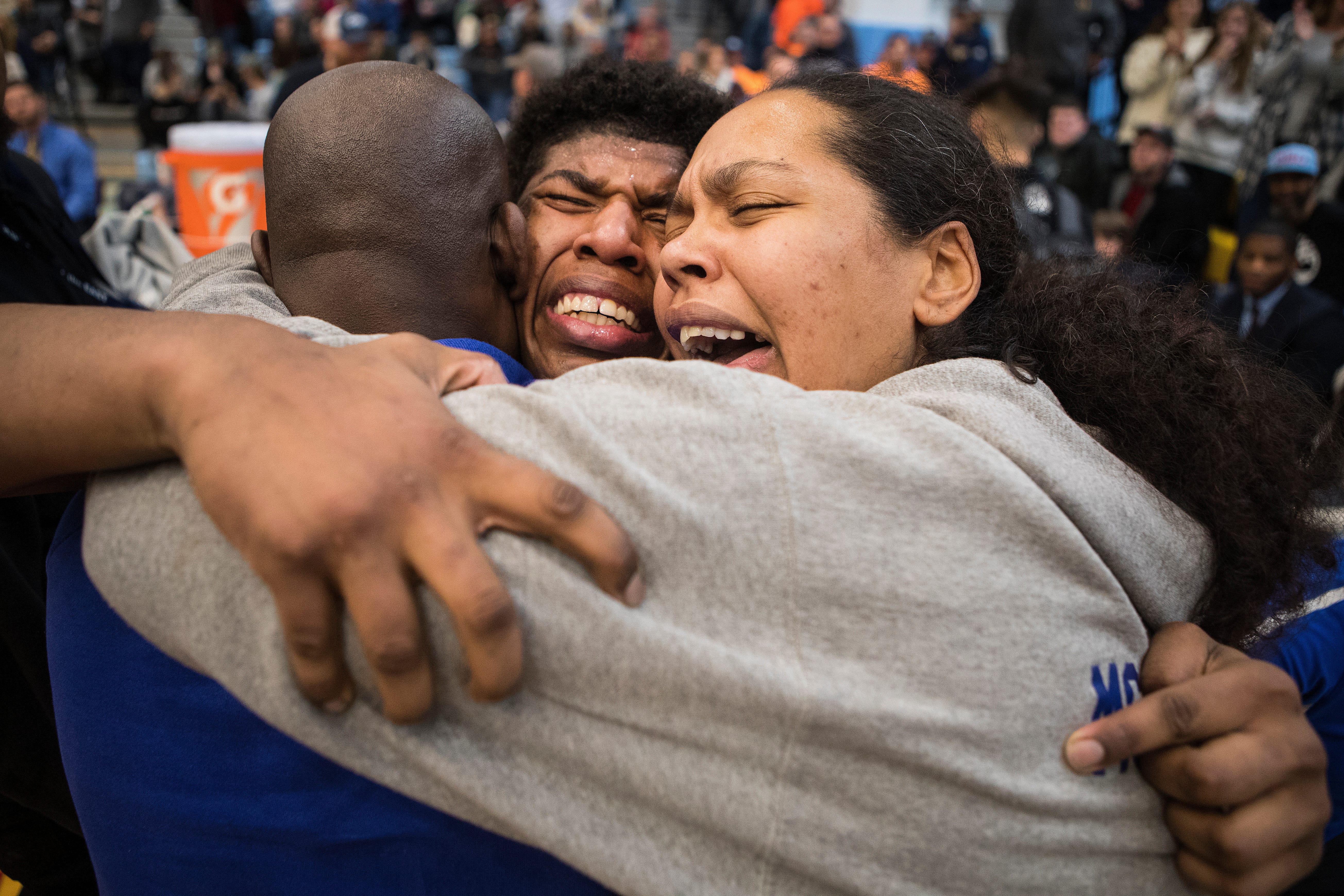 A.I. Dupont's Azeem Bell, center, is overcome with emotion with his father and coach Ian Bell, left, and mother Heather Bell after winning the 195 pound class in the DIAA Individual Wrestling Tournament Saturday at Cape Henlopen High School. 