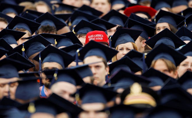 A graduate wears a Make America Great Again hat amidst a sea of mortar boards before the start of commencement exercises at Liberty University in Lynchburg, Virginia, U.S., May 11, 2019.  REUTERS/Jonathan Drake - RC1AA7FBD110