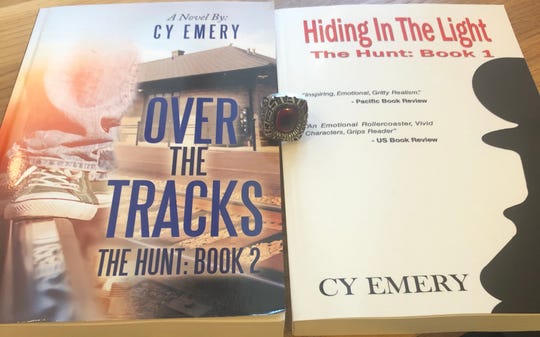 The two Emery Cook books he published with his 1997 state championship ring in the middle.