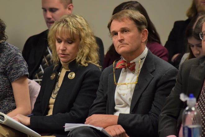 Department of Health and Senior Services Director Randall Williams, right, with bowtie, listens to testimony during a meeting on the state's preparations for the coronavirus on Monday, March 2, 2020.