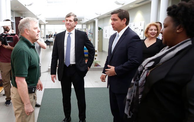 (From left) Andrew Cannons, Laboratory Director at the Bureau of Public Health Laboratories, takes State Surgeon General Dr. Scott Rivkees, Governor Ron DeSantis, Deputy Secretary for Health Dr. Shamarial Roberson on a tour of the labs where potential cases of the coronavirus will be tested at the Florida Department of Health Laboratory in Tampa, Florida on March 2, 2020.