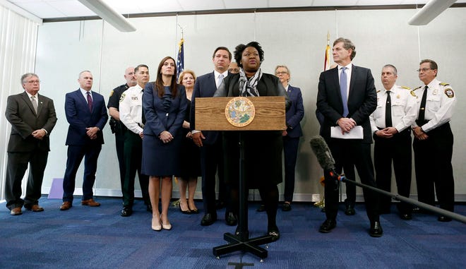 Florida Deputy Secretary for Health Dr. Shamarial Roberson, center, speaks about the confirmed coronavirus cases in Hillsborough and Manatee Counties while other local and state officials are in attendance during a press conference at the Florida Department of Health Laboratory in Tampa, Florida on Monday, March 2, 2020.