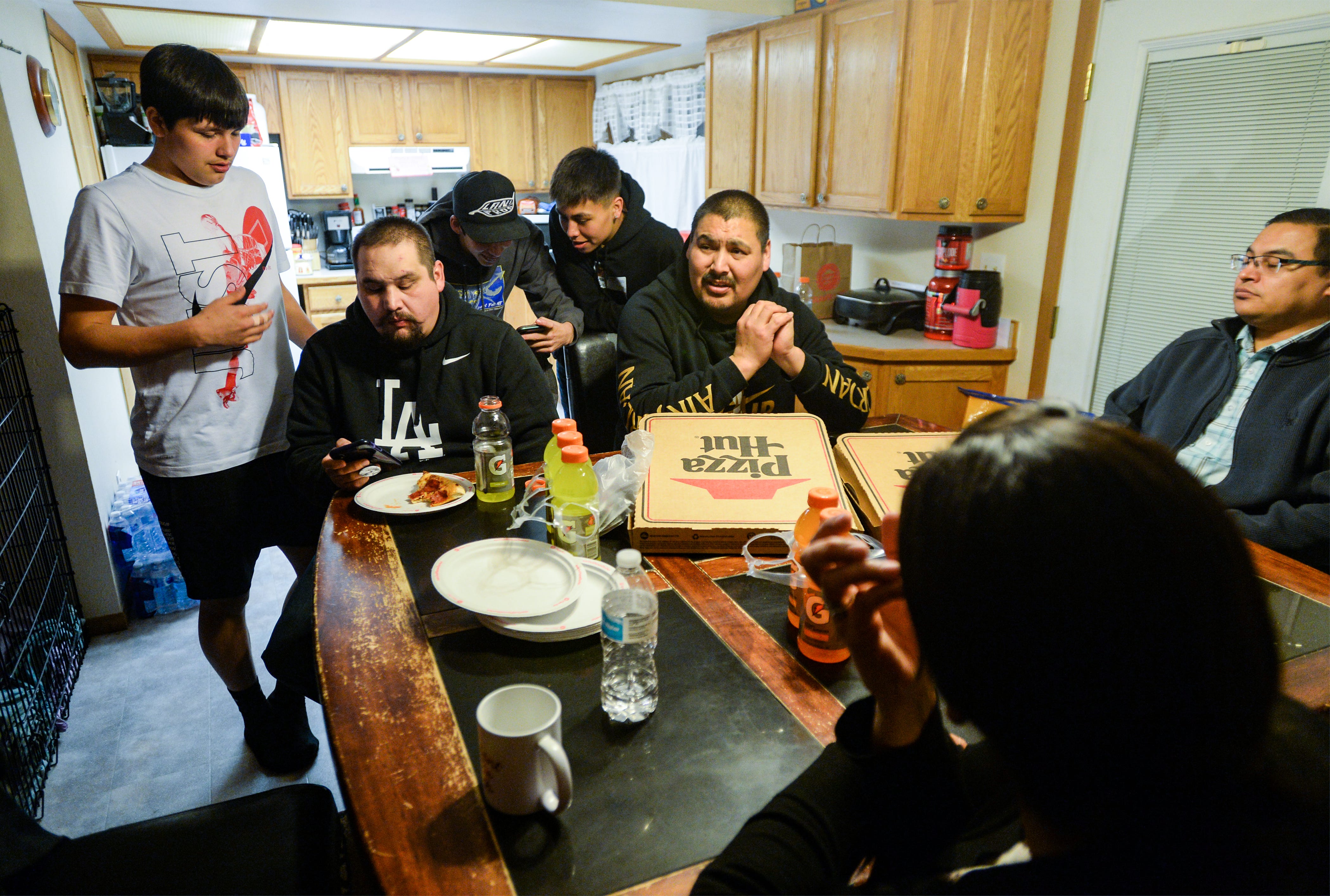 Rocky Boy boys' basketball coach Adam Demontiney hosts pizza dinners at his home before big tournaments to get the team together away from the basketball court.