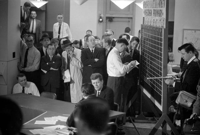 Sen. John F. Kennedy of Massachusetts, center, is interviewed by NBC reporter Sander Vanocur in The Milwaukee Journal newsroom on April 5, 1960, the night of the Wisconsin primary election. Kennedy's chief rival, Sen. Hubert Humphrey of Minnesota, is seen standing behind Kennedy with his arms folded. At right, votes are tallied on a chalkboard while a member of the TV crew holds a boom mic to pick up the interview. This photo was published in the April 6, 1960, Milwaukee Journal. For many years, readers have relied on newspapers to keep them informed and hold the powerful to account, but that vital mission has gotten harder as reading habits have rapidly shifted.