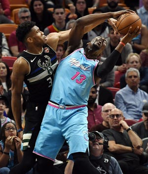 Bucks forward Giannis Antetokounmpo defends Miami Heat forward Bam Adebayo in the first quarter.