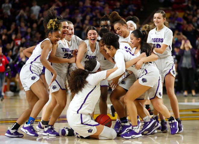 Millennium charges the court after winning the 5A State Championship game at Desert Financial Arena over Sunrise Mountain in Tempe, Ariz. on March 2, 2020. 