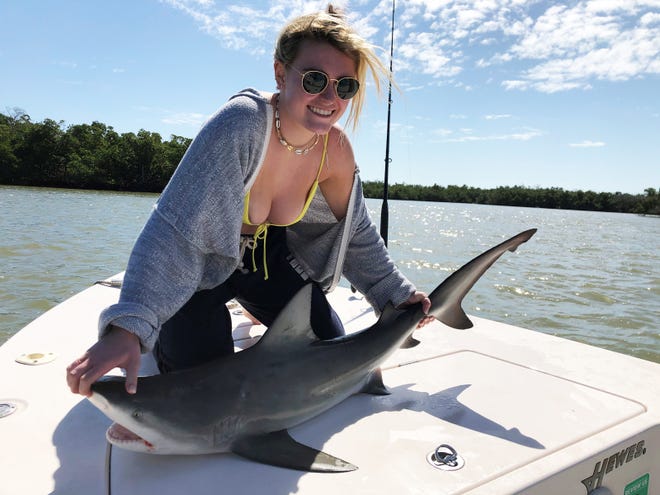 Lily “shark” Finn with a catch, tag and released bull shark caught in the Everglades. 