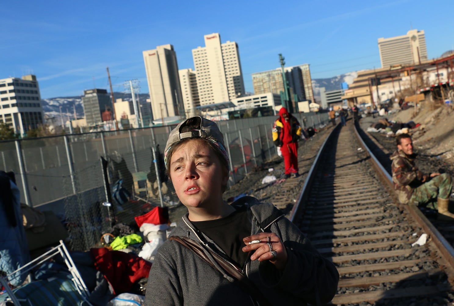 19 year old Moriah Stovall smokes a cigarette while getting evicted from a homeless encampment along the railroad tracks in Reno on March 4, 2020.