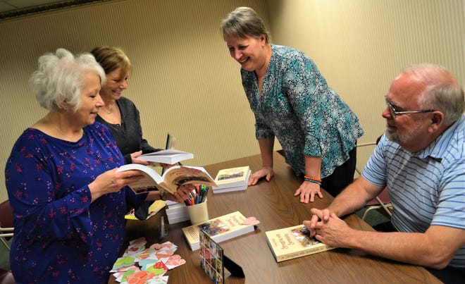 Cindy and John Kolbe, on the right, traveled to Fremont from their home in West Virginia, to host an Author Talk and Signing at Birchard Public Library on March 2. Here, they talk about Cindy’s book, “Struggling with Serendipity,” with Dianne Hopfer of Toledo, left, and Roxanne Esterline of Sylvania.