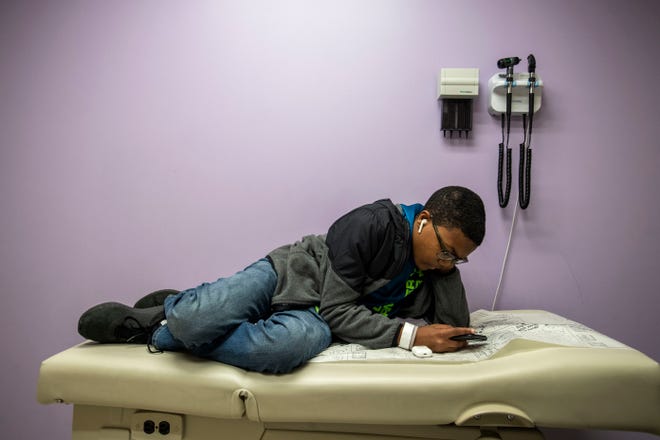 Dallas Weddle, 13-years-old, lays on the exam table waiting for his gastroenterologist Dr. Mark R. Corkins, at Lebonheur Hospital in Memphis, Tenn., Friday, Jan. 3, 2020. Weddle was born with Familial adenomatous polyposis with Garnders Syndrome which means there's tumors all over his body.