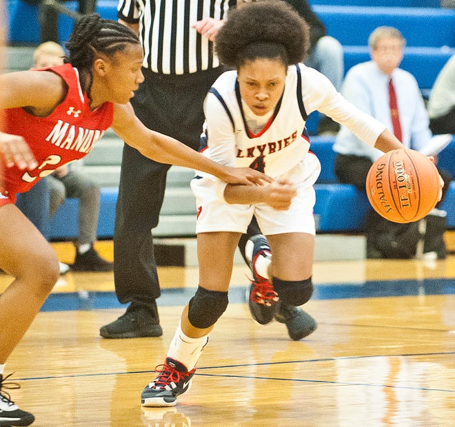 DuPont Manual guard Madison Brittle reaches in on Sacred Heart guard Triniti Ralston in the KHSAA Region 7 Girls Basketball Tournament semi-final game at Valley H.S.March 04,  2020