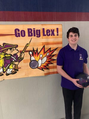 Scott Oliver, in front of the banner that hangs inside Lex Lanes, is the reigning Ohio Cardinal Conference Player of the Year and Lexington's first two-time state qualifier