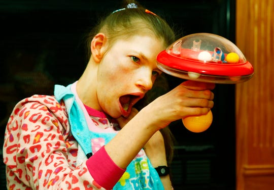 Megan Hess plays with her new top. Noelle Bye, Times-Gazette.com