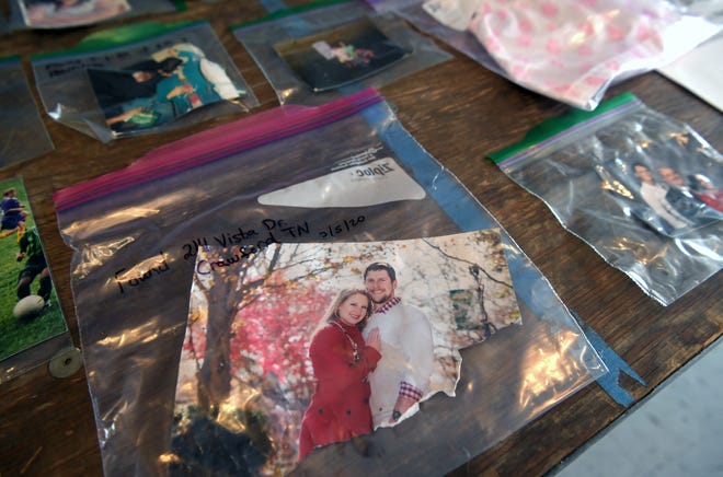 A table at the Cookeville community center contains photographs found after the tornado. Photographs and other lost and found objects were on display Thursday, March 5, 2020.