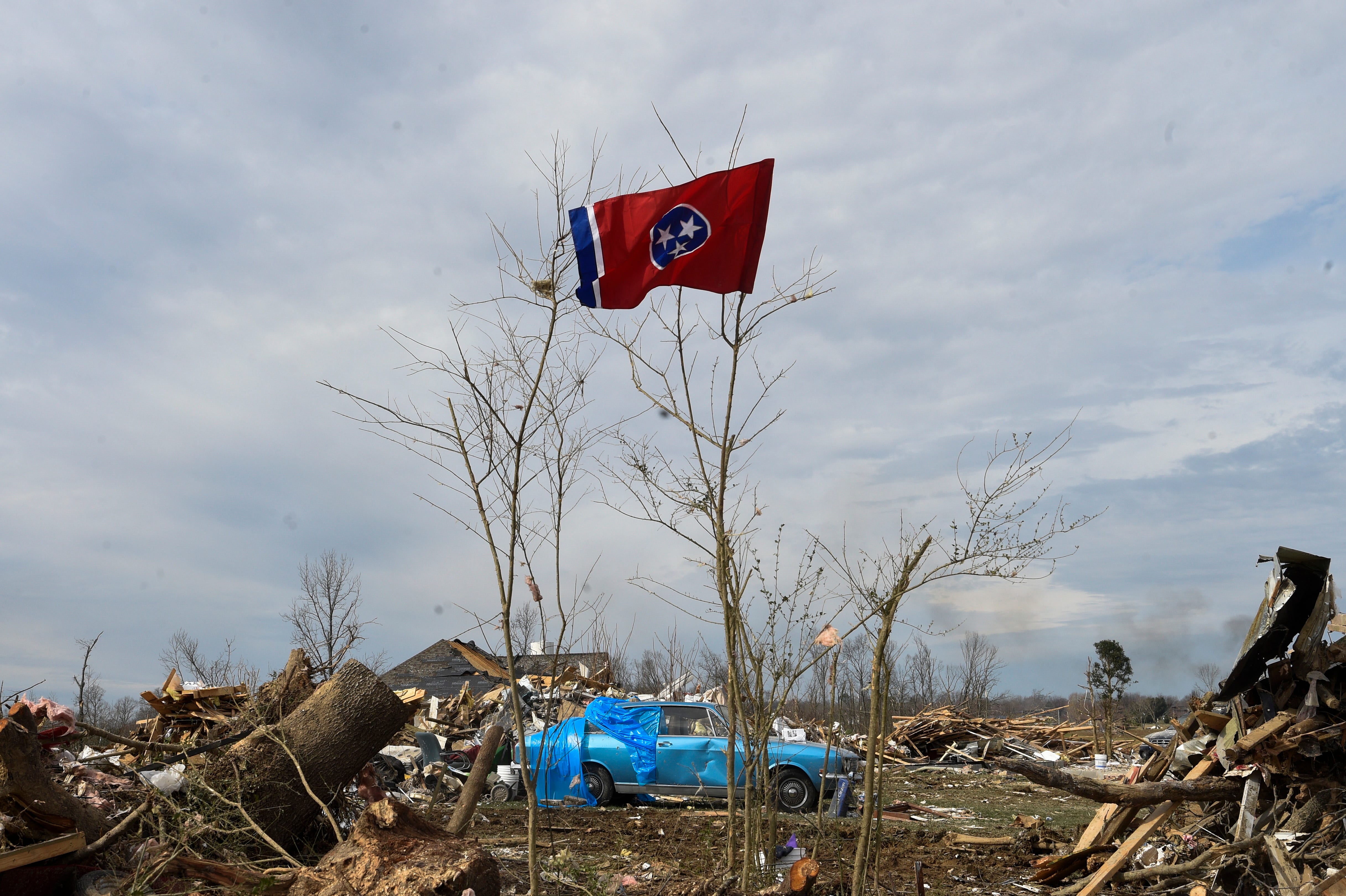 The state flag flies amid rubble on Charlton Square in Baxter, Tenn., on Wednesday, March 5, 2020.