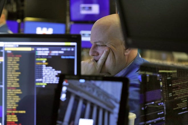 A trader studies his screens as he prepares for the day's activities on the floor of the New York Stock Exchange, Friday, March 6, 2020. (AP Photo/Richard Drew)