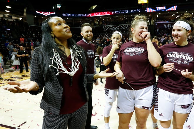 Missouri State Lady Bears head coach Amaka Agugua-Hamilton shows off the cut down net after the Lady Bears beat the Valparaiso Crusaders 85-70 to win the Missouri Valley Conference regular-season title at JQH Arena on Thursday, March 5, 2020.