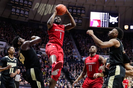 Rutgers forward Akwasi Yeboah (1) shoots between strikers Purdue Trevion Williams (50) and Aaron Wheeler (1) during the first half of an NCAA basketball game in West Lafayette, Ind.