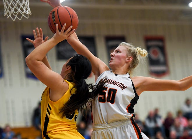 Washington's Sydni Schetnan (50) blocks a shot by Mitchell during the game on Friday, March 6, 2020 at Washington High School in Sioux Falls.