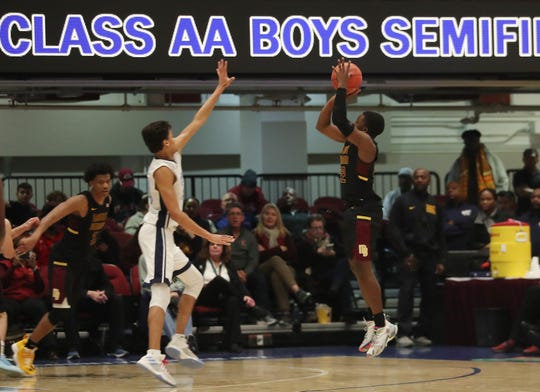 Mt. Vernir Nazir Davis (22) hits a 3-point overtime hit against Suffern in the Boys' AA class semifinal at the Westchester County Center in White Plains on March 6, 2020. Mt. Vernon won 56-50 in overtime .