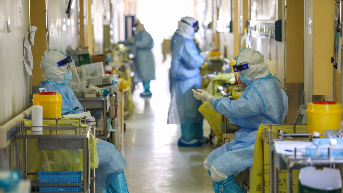 This photo taken on March 6, 2020 shows medical staff waiting outside rooms at the Red Cross hospital in Wuhan in China's central Hubei province.