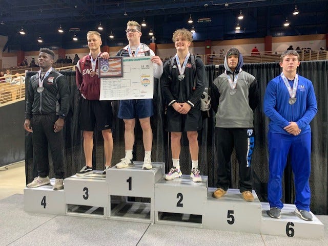 Pace's Gabe Jacobs (third from left) stands atop the Class 2A 195-pound weight class podium after winning the Pensacola's first public school state wrestling championship in March in Kissimmee.