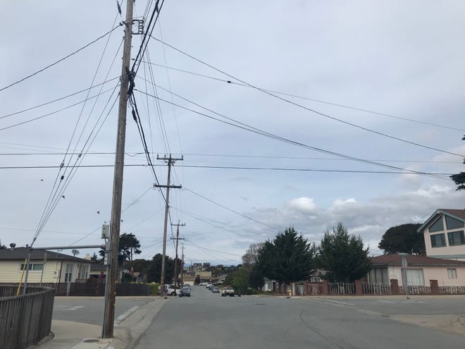Power and telephone lines outside a home in Seaside. March 8, 2020.
