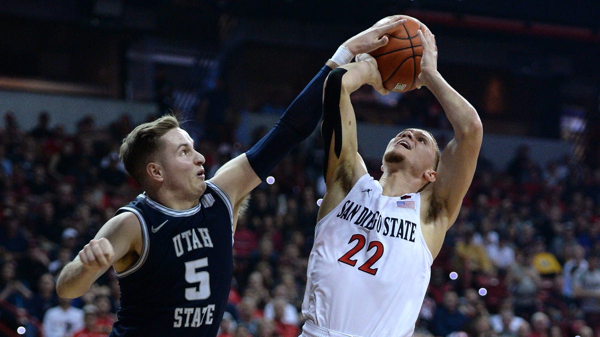 Utah State Aggies guard Sam Merrill (5) blocks a shot from San Diego State Aztecs guard Malachi Flynn (22) during the first half of the Mountain West Conference tournament final at Thomas and Mack Center.