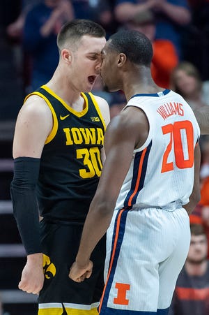Iowa Hawkeyes guard Connor McCaffery (30) and Illinois Fighting Illini guard Da'Monte Williams (20) confront each other, afterwards receiving each a technical foul, during the first half at State Farm Center.