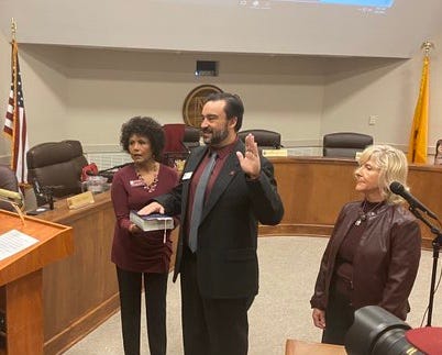 New Mexico State University Regent Arsenio Romero, center, is flanked by regents Ammu Devasthali, left, and Deb Hicks, right, as he is sworn in ahead of his first board of regents meeting on Monday, March 9, 2020.