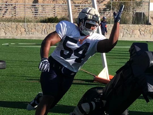 UTEP defensive tackle Keenan Steward runs through a tackling dummy during spring practice Monday at Glory Field