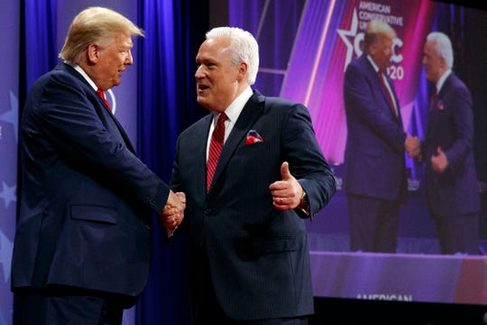 President Donald Trump is greeted by Matt Schlapp, Chairman of the American Conservative Union, as the president arrives to speak at the Conservative Political Action Conference, CPAC 2020, at National Harbor, in Oxon Hill, Md.