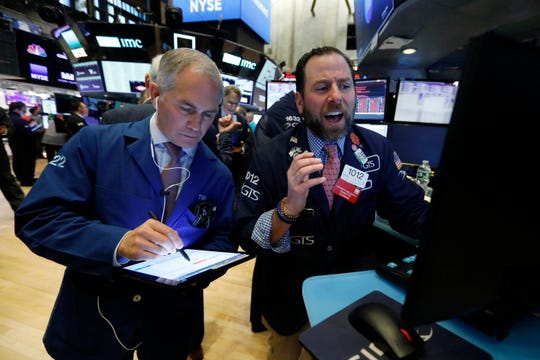 Trader Timothy Nick, left, and specialist Michael Pistillo work on the floor of the New York Stock Exchange on March 9. U.S. stocks collapsed after a free fall in oil prices and mounting coronavirus cases ratcheted up fear among investors and threatened to snuff out the longest bull market on the very day it was supposed to turn 11.
