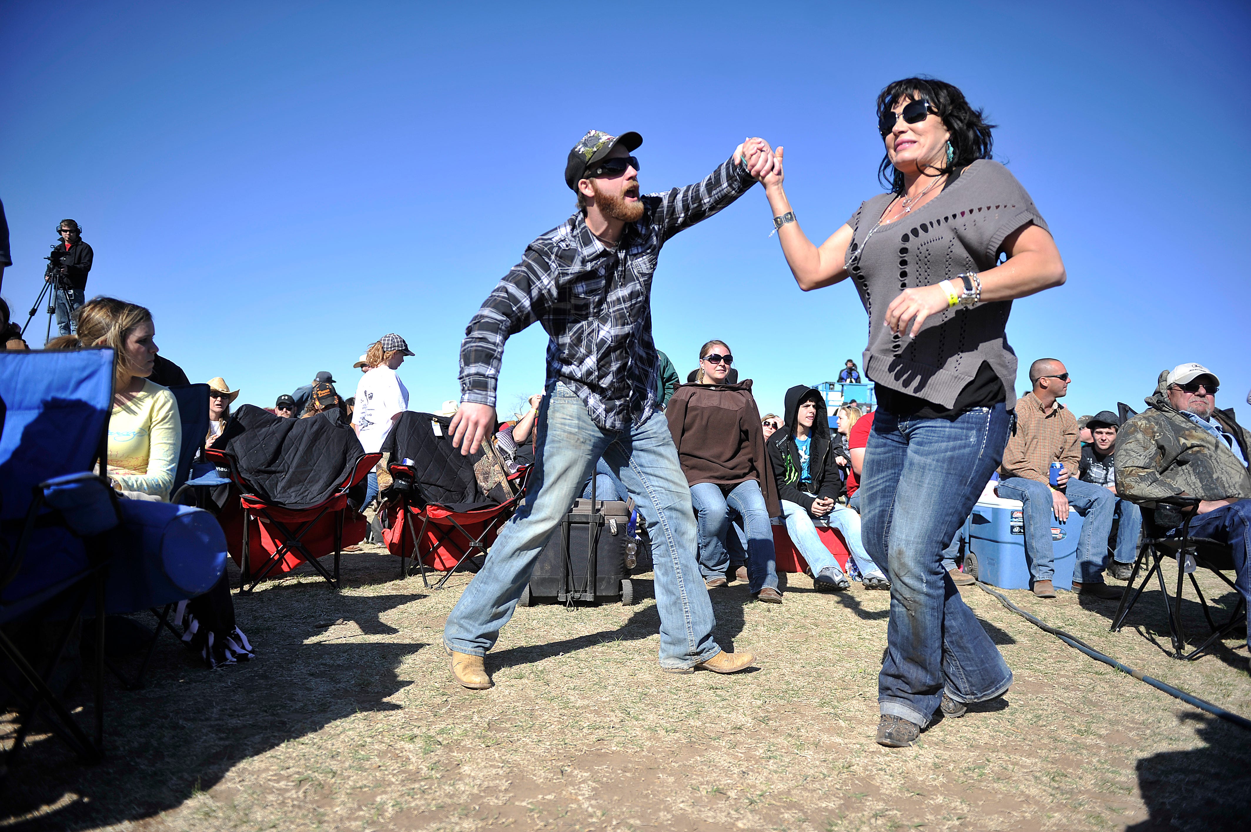 Jared Scott, left, and Shayla Griffon of Potosi dance while Bleu Edmondson plays during the Outlaws & Legends festival at Joe Allen's Lytle Bend Ranch on Saturday, March 5, 2011.