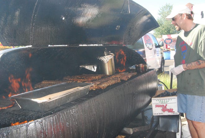 Art Weems of Big Arts BBQ&Grill looks over the ribs on the barbecue at the Taste of Colerain.