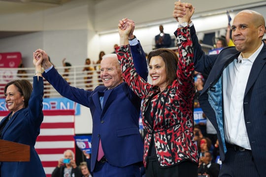 (Left to right) U.S. Sen. Kamala Harris of California,  Democratic presidential candidate and former Vice President Joe Biden, Michigan Governor Gretchen Whitmer and U.S. Sen. Cory Booker raise arms after Biden takes the stage to speak to a crowd during a Get Out the Vote event at Renaissance High School in Detroit on Monday, March 9, 2020. 
