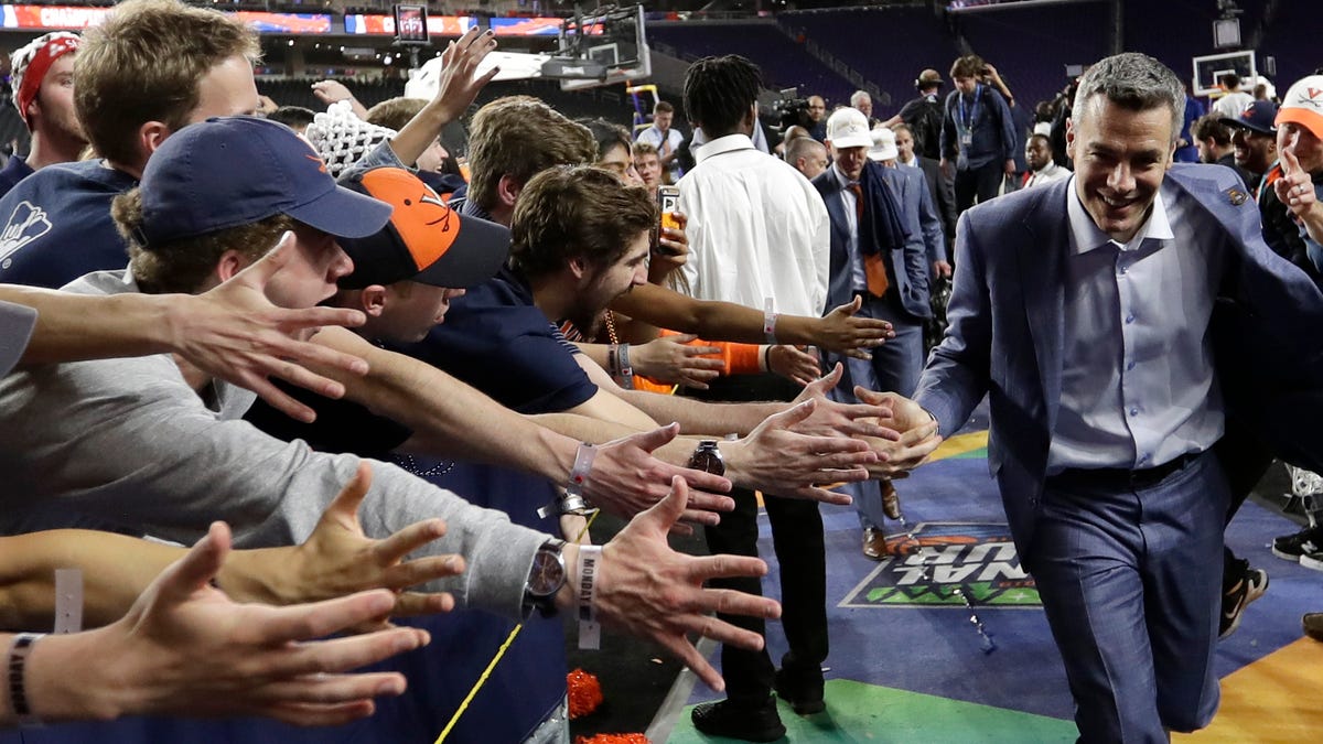 Virginia head coach Tony Bennett celebrates with fans after the championship game against Texas Tech in Minneapolis in 2019.