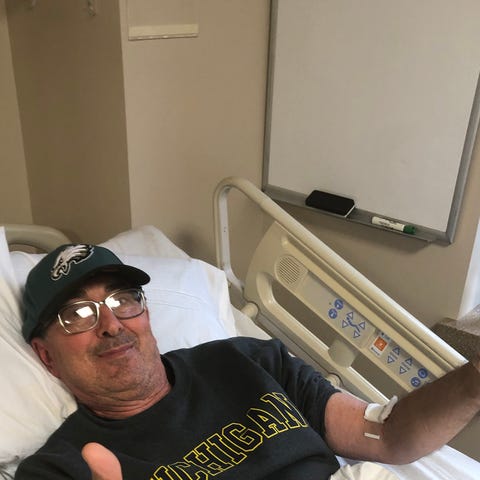 Carl Goodman gives a thumbs up from his hospital b