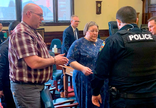 In this Monday, March 9, 2020 photo, Jonathan James Hay, left, and Debra Ann Hay, center, are led out of district court after they were sentenced to 13 years in prison for abusing their adopted 12-year-old son while living in Butte.