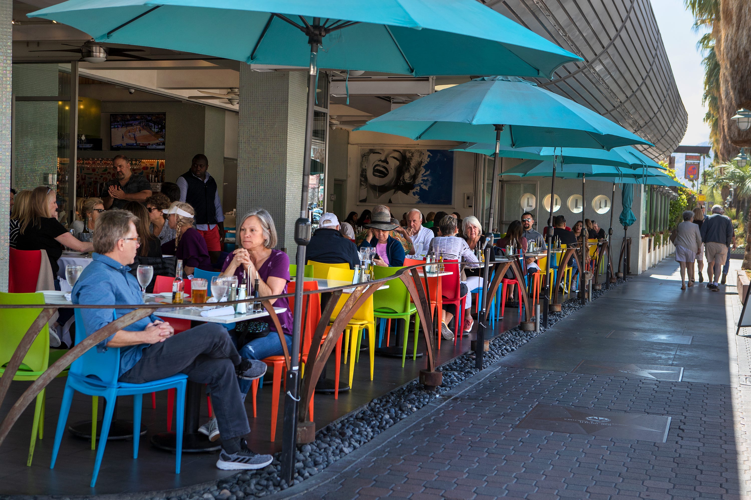 People eat lunch at Lulu California Bistro in downtown Palm Springs, Calif., on Wednesday, March 11, 2020. Earlier in the day, the World Health Organization declared the coronavirus outbreak a pandemic.