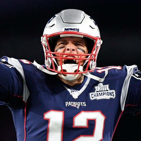 New England Patriots quarterback Tom Brady (12) re