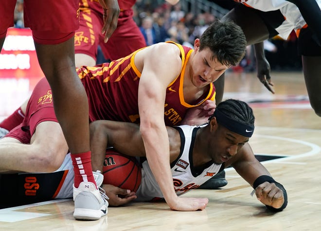 Oklahoma State Cowboys forward Cameron McGriff (bottom) and Iowa State Cyclones forward Michael Jacobson (top) fight for a loose ball during the first half at Sprint Center on March 11, 2020.